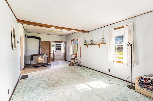 4293 N Schoenherr Rd, Fountain, MI 49410 - unfurnished living room with healthy amount of natural light, carpet floors, and a wood stove