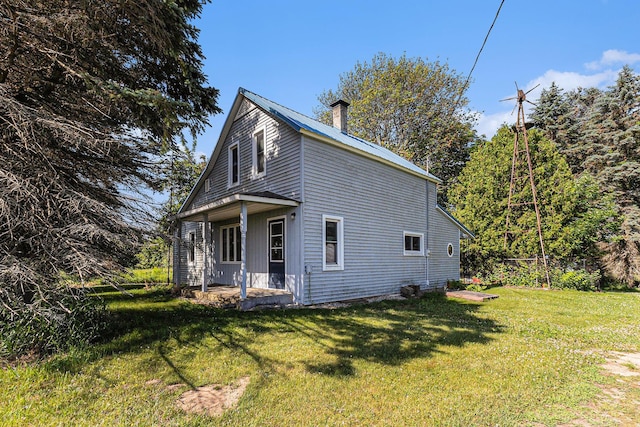 4293 N Schoenherr Rd, Fountain, MI 49410 - view of side of property featuring a yard and a chimney