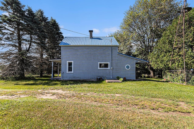 4293 N Schoenherr Rd, Fountain, MI 49410 - view of side of property featuring a yard and a metal roof