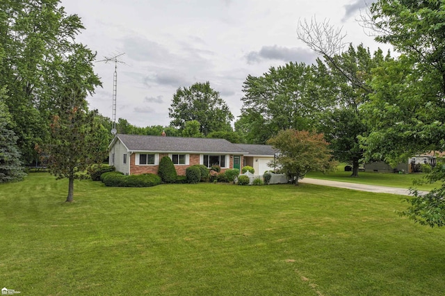 6494 W Coldwater Rd, Flushing, MI 48433 - single story home with driveway, an attached garage, a front yard, brick siding, and a chimney