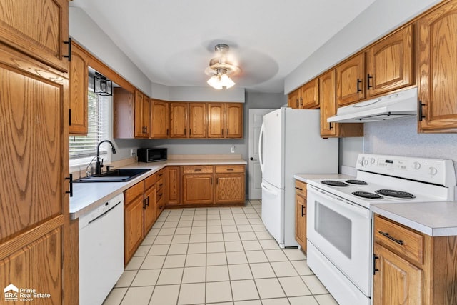 6494 W Coldwater Rd, Flushing, MI 48433 - kitchen with white appliances, under cabinet range hood, light countertops, brown cabinetry, and light tile patterned flooring