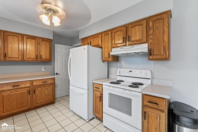 6494 W Coldwater Rd, Flushing, MI 48433 - kitchen with white appliances, under cabinet range hood, brown cabinetry, light countertops, and light tile patterned floors