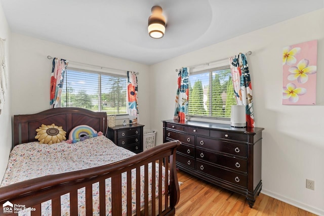 6494 W Coldwater Rd, Flushing, MI 48433 - bedroom with light wood-style flooring and baseboards