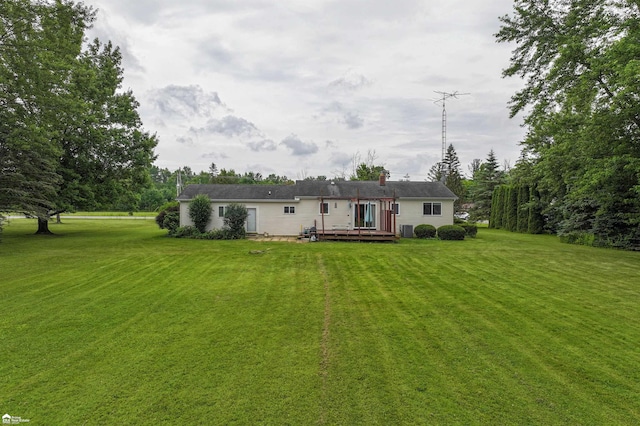 6494 W Coldwater Rd, Flushing, MI 48433 - back of house with a yard, a wooden deck, and a chimney