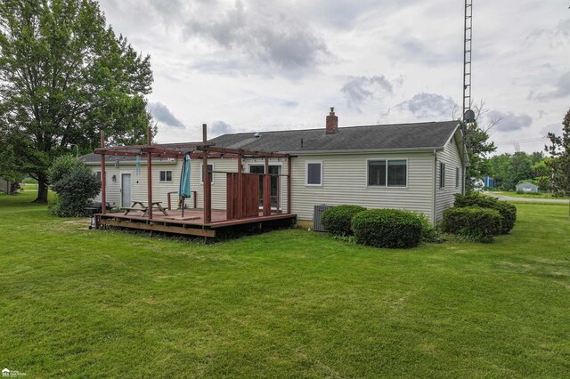 6494 W Coldwater Rd, Flushing, MI 48433 - rear view of house with a pergola, a deck, a yard, and a chimney