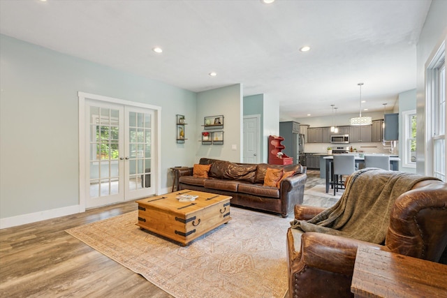 7987 36th St SE, Ada, MI 49301 - living room with light wood finished floors, recessed lighting, and french doors