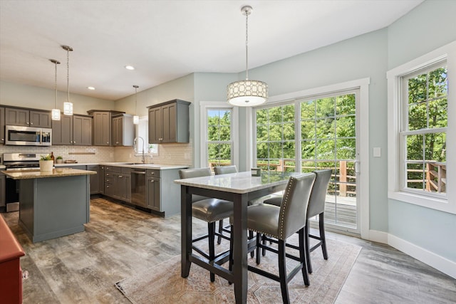 7987 36th St SE, Ada, MI 49301 - dining room featuring light wood finished floors and recessed lighting