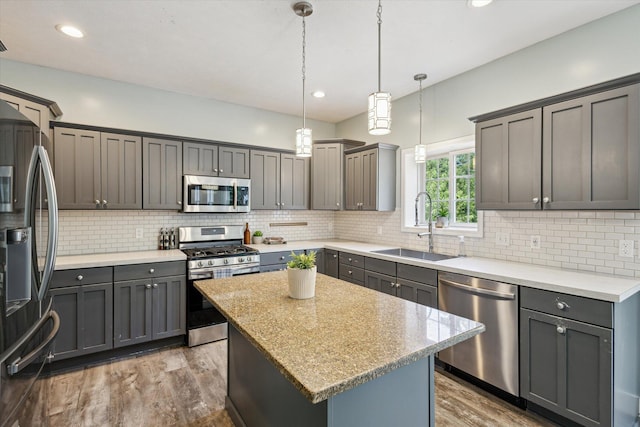 7987 36th St SE, Ada, MI 49301 - kitchen featuring stainless steel appliances, wood finished floors, backsplash, gray cabinets, and recessed lighting