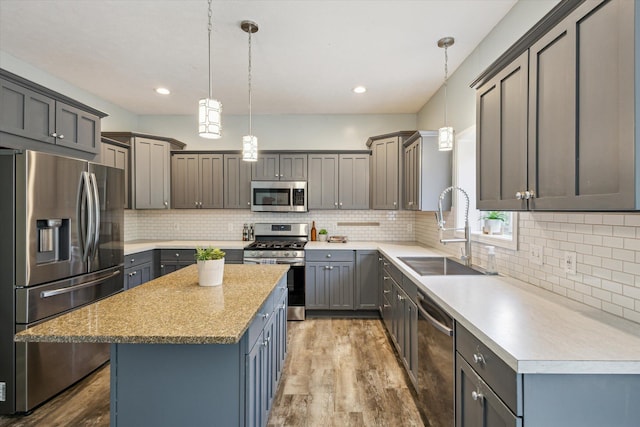 7987 36th St SE, Ada, MI 49301 - kitchen featuring appliances with stainless steel finishes, wood finished floors, tasteful backsplash, and recessed lighting
