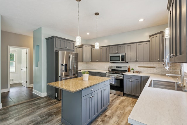 7987 36th St SE, Ada, MI 49301 - kitchen featuring stainless steel appliances, a kitchen island, backsplash, dark wood-style floors, and recessed lighting