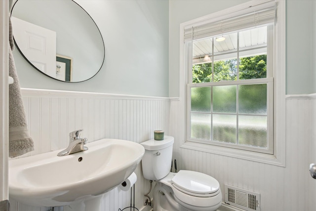 7987 36th St SE, Ada, MI 49301 - bathroom featuring a wainscoted wall and toilet