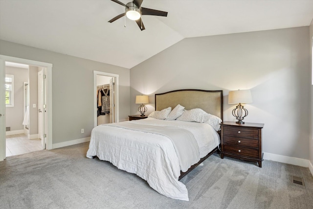 7987 36th St SE, Ada, MI 49301 - bedroom featuring carpet flooring, a walk in closet, vaulted ceiling, a closet, and connected bathroom