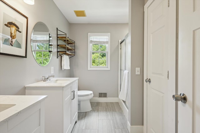 7987 36th St SE, Ada, MI 49301 - full bath featuring two vanities, plenty of natural light, and a shower with shower door