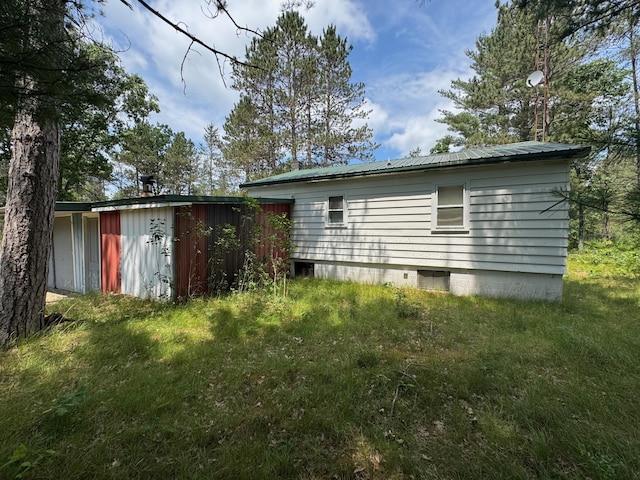 4231 W 5 Mile Rd, Irons, MI 49644 - back of house featuring a metal roof and a storage shed