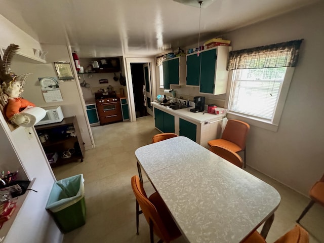 4231 W 5 Mile Rd, Irons, MI 49644 - kitchen with light floors, light countertops, and white microwave