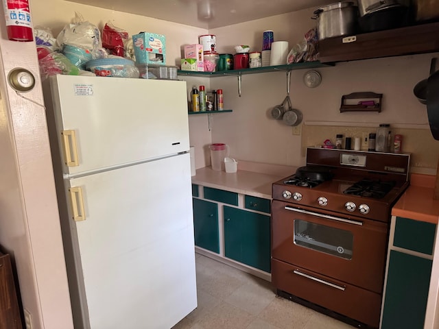 4231 W 5 Mile Rd, Irons, MI 49644 - kitchen with freestanding refrigerator, black range with gas cooktop, open shelves, and light countertops