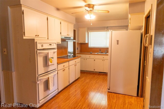 25640 Grand Concourse St, Southfield, MI 48075 - kitchen featuring white appliances, under cabinet range hood, a ceiling fan, light wood-type flooring, and white cabinetry