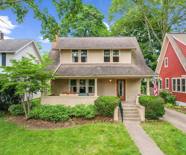 216 Kenwood Ave, Ann Arbor, MI 48103 - view of front of house featuring covered porch, a chimney, stucco siding, and a front lawn