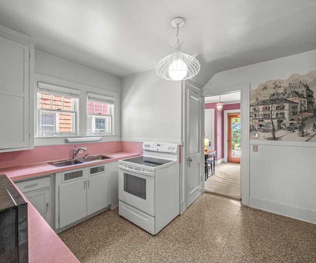 216 Kenwood Ave, Ann Arbor, MI 48103 - kitchen featuring white range with electric stovetop, healthy amount of natural light, light countertops, and decorative light fixtures