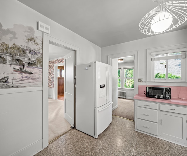 216 Kenwood Ave, Ann Arbor, MI 48103 - kitchen featuring white refrigerator with ice dispenser, radiator heating unit, white cabinets, and light countertops