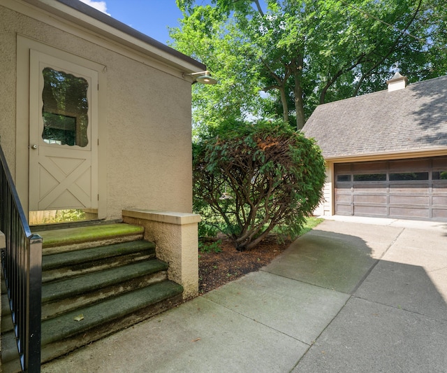 216 Kenwood Ave, Ann Arbor, MI 48103 - entrance to property with stucco siding and a detached garage