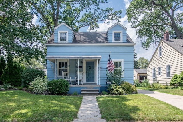 407 Flowerdale St, Ferndale, MI 48220 - cape cod house featuring a front yard and a porch