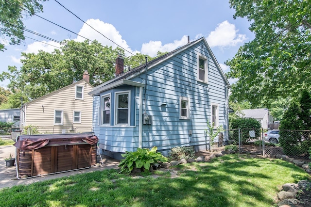 407 Flowerdale St, Ferndale, MI 48220 - view of side of property with a hot tub and a chimney