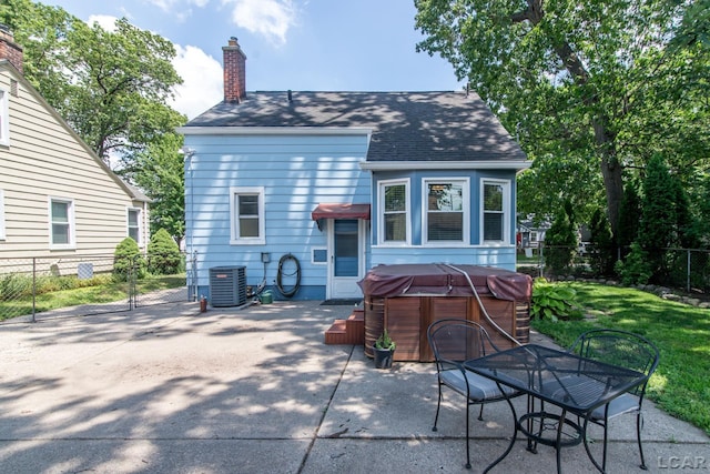 407 Flowerdale St, Ferndale, MI 48220 - rear view of house featuring a hot tub, a patio area, roof with shingles, and a chimney