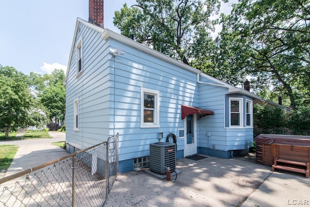 407 Flowerdale St, Ferndale, MI 48220 - back of property featuring a hot tub, a chimney, and a patio