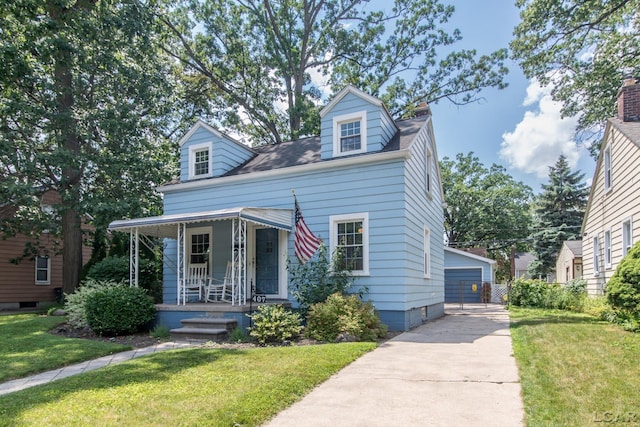 407 Flowerdale St, Ferndale, MI 48220 - cape cod-style house with a porch, a front lawn, a detached garage, and an outdoor structure