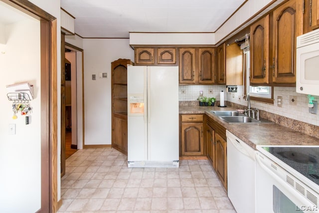 407 Flowerdale St, Ferndale, MI 48220 - kitchen featuring white appliances, brown cabinets, and decorative backsplash