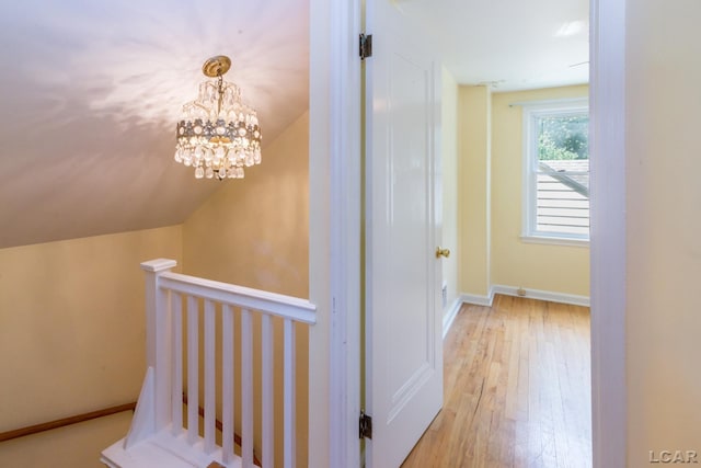 407 Flowerdale St, Ferndale, MI 48220 - corridor featuring an upstairs landing, a chandelier, light wood-type flooring, and vaulted ceiling