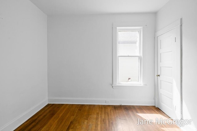 256 W Forest Ave, Muskegon, MI 49441 - empty room with baseboards and dark wood-style flooring