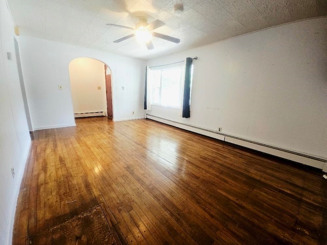 1308 W Broadway, Mount Pleasant, MI 48858 - empty room with a baseboard radiator, arched walkways, ceiling fan, and hardwood / wood-style flooring