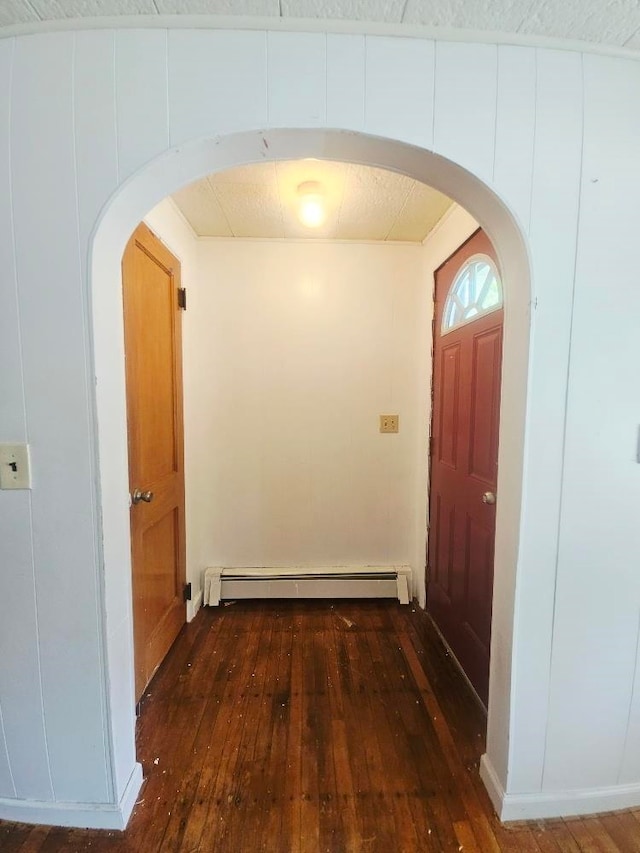 1308 W Broadway, Mount Pleasant, MI 48858 - hall featuring arched walkways, hardwood / wood-style flooring, and a baseboard radiator