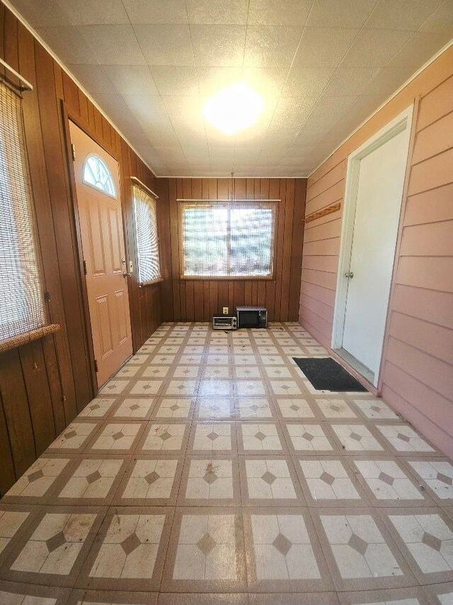 1308 W Broadway, Mount Pleasant, MI 48858 - entryway featuring wood walls and tile patterned floors