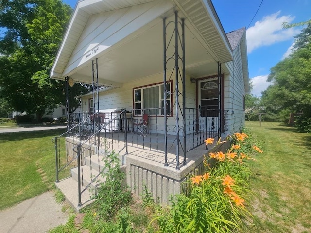 1308 W Broadway, Mount Pleasant, MI 48858 - view of front of property with a porch and a front lawn