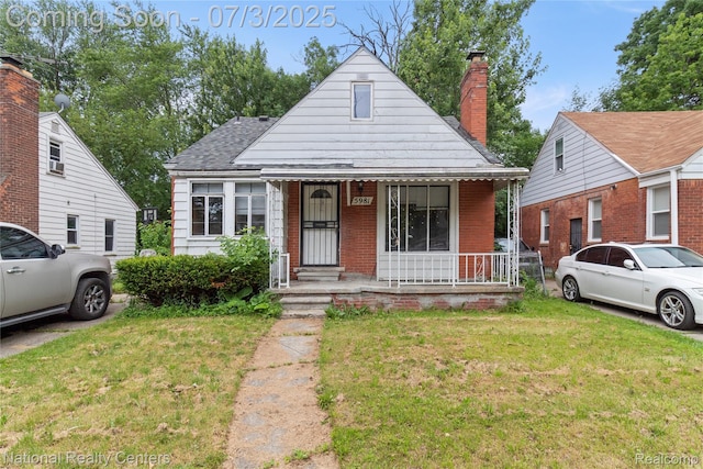 5981 University Pl, Detroit, MI 48224 - bungalow-style home featuring covered porch, a front yard, a shingled roof, a chimney, and brick siding