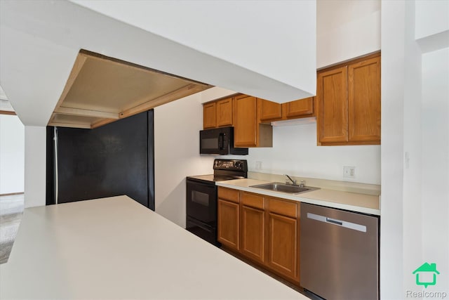 45833 Wildrye Ct, Van Buren, MI 48111 - kitchen with black appliances, light countertops, and brown cabinetry