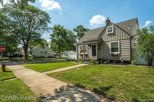 2001 Brockton Ave, Royal Oak, MI 48067 - view of front of home with board and batten siding, a chimney, and a shingled roof