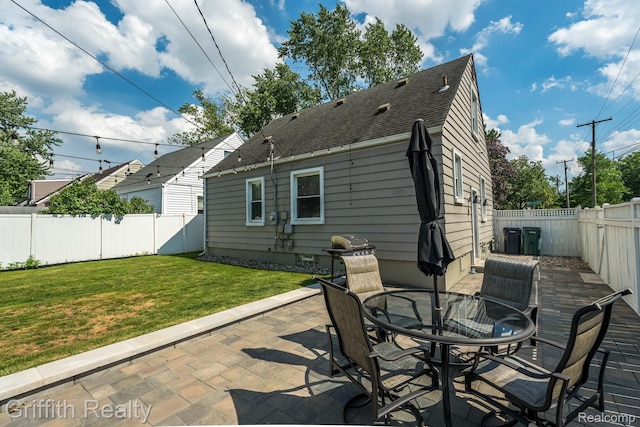 2001 Brockton Ave, Royal Oak, MI 48067 - back of property with a patio area, a fenced backyard, a shingled roof, and outdoor dining space