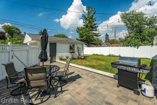 2001 Brockton Ave, Royal Oak, MI 48067 - fenced backyard with grilling area, a patio area, outdoor dining space, a gate, and an outbuilding