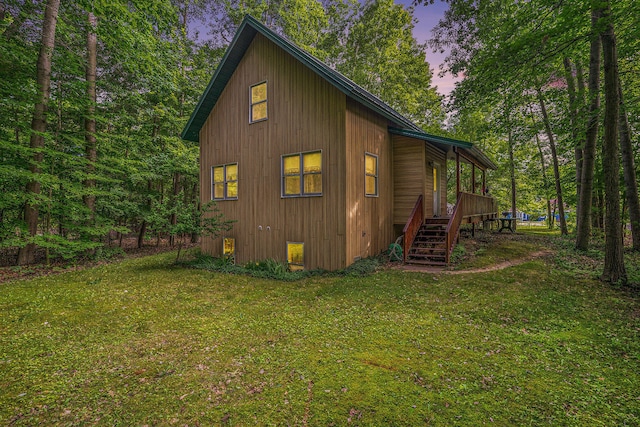 9191 W Ranger Rd, Mears, MI 49436 - view of property exterior featuring stairway and a yard