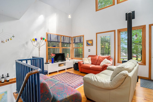 9191 W Ranger Rd, Mears, MI 49436 - living area featuring wood finished floors and high vaulted ceiling