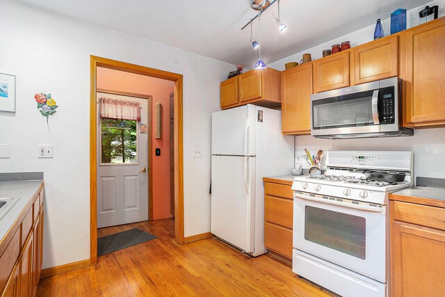 9191 W Ranger Rd, Mears, MI 49436 - kitchen with white appliances and light wood-style flooring