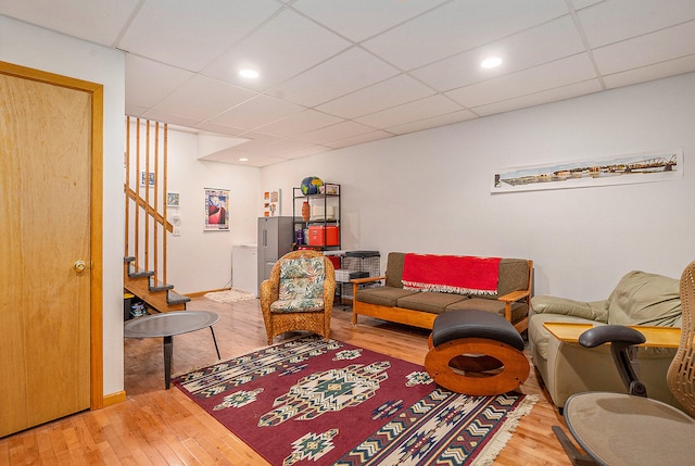 9191 W Ranger Rd, Mears, MI 49436 - living room with hardwood / wood-style flooring, stairs, and a paneled ceiling