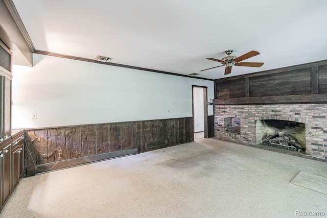 6674 Balmoral Ter, Clarkston, MI 48346 - unfurnished living room featuring ceiling fan, wooden walls, a brick fireplace, crown molding, and wainscoting