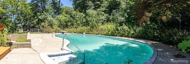 6674 Balmoral Ter, Clarkston, MI 48346 - outdoor pool featuring view of scattered trees and a patio area