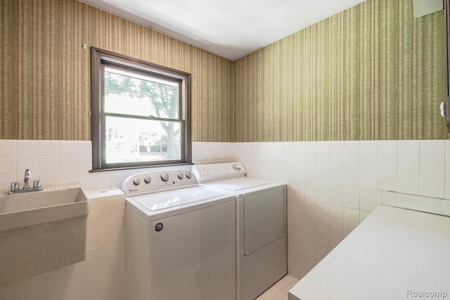 6674 Balmoral Ter, Clarkston, MI 48346 - laundry room featuring separate washer and dryer, wallpapered walls, tile walls, wainscoting, and light tile patterned flooring