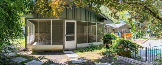 6674 Balmoral Ter, Clarkston, MI 48346 - rear view of property featuring board and batten siding and a sunroom